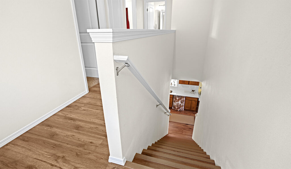 The stairs upgraded to vinyl in this custom home.