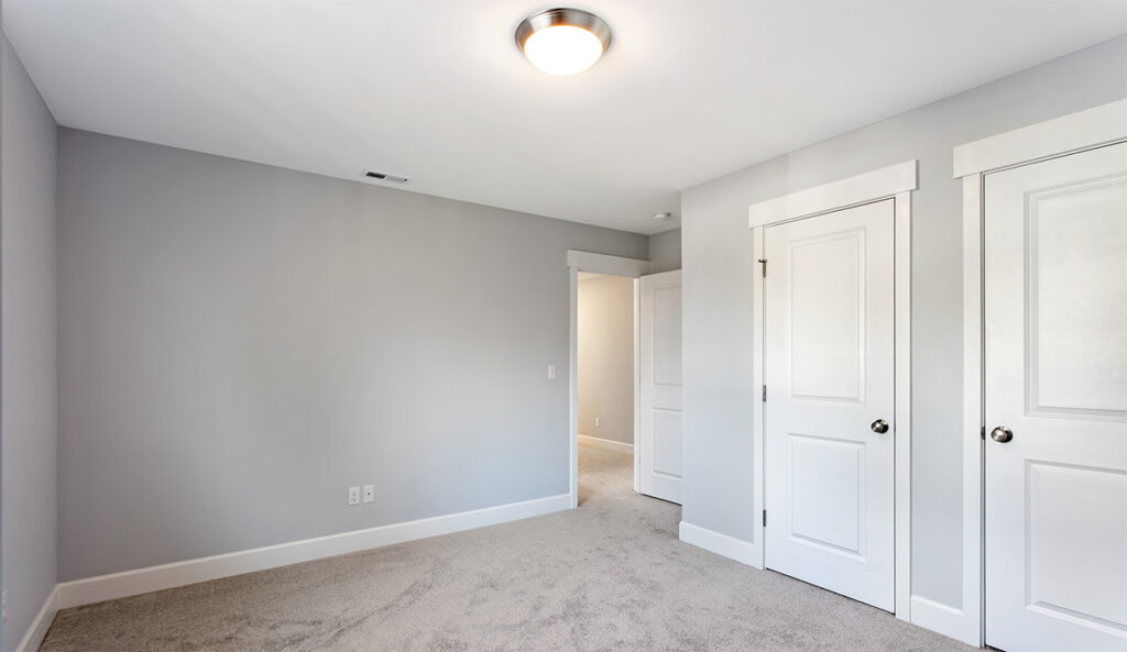 Additional bedroom showing closets.