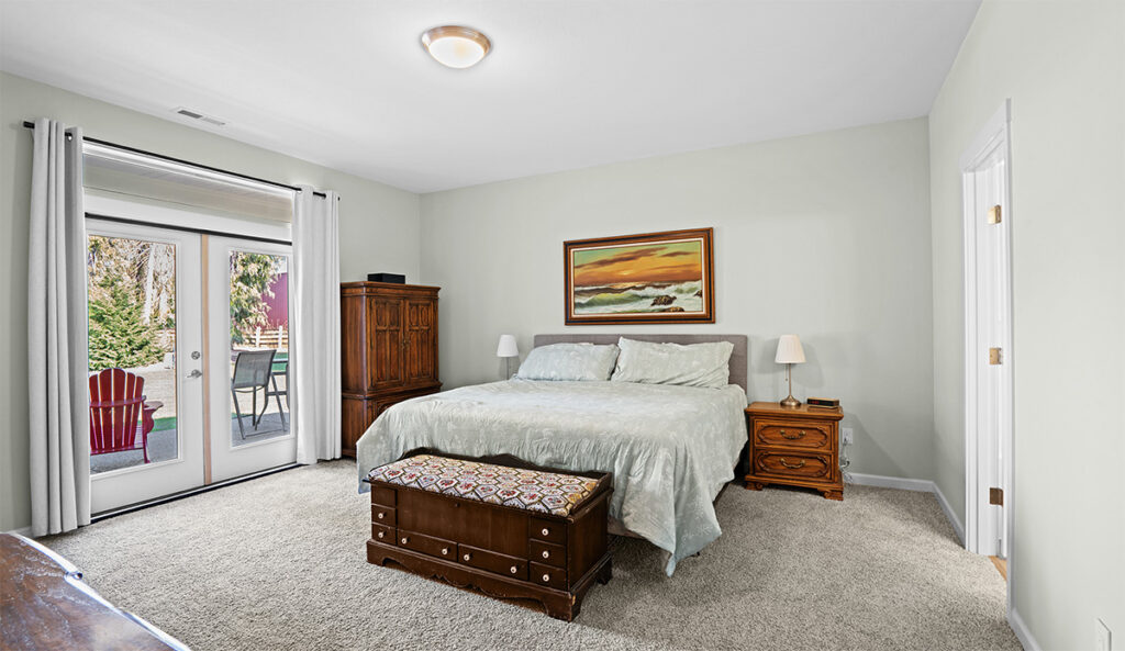 Primary suite in custom home plan 2443 with added patio access.