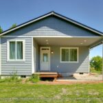 Home Plan 800 back exterior outdoor living space covered porch and storage.