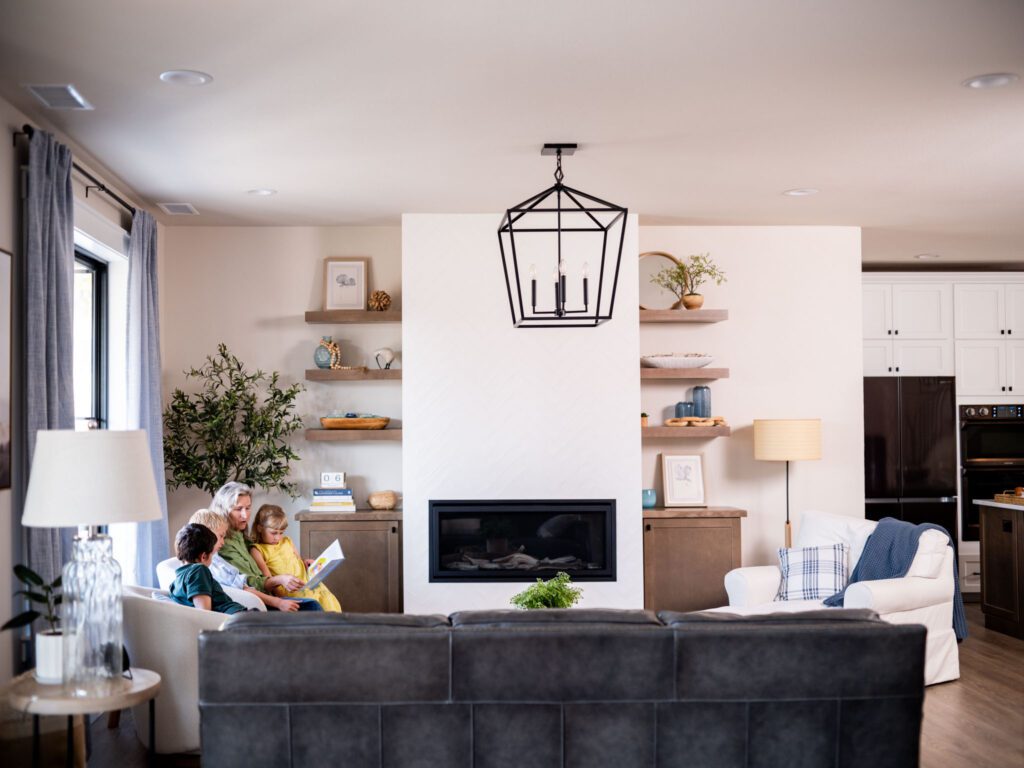 Grandma sitting in living room reading to her grandkids.