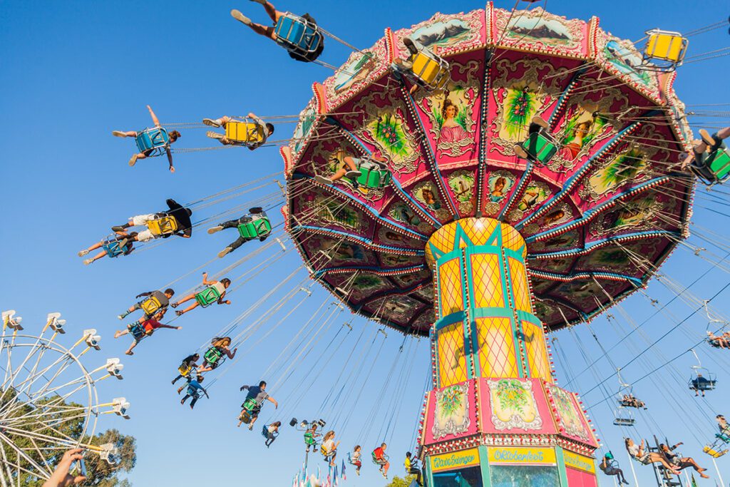 Beautifully painted, traditional fairground ride, swings or chair-o-plane, at the fair.