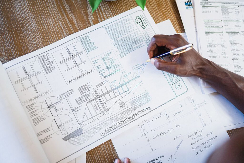 A HiLine Homes consultant going over floorplans.