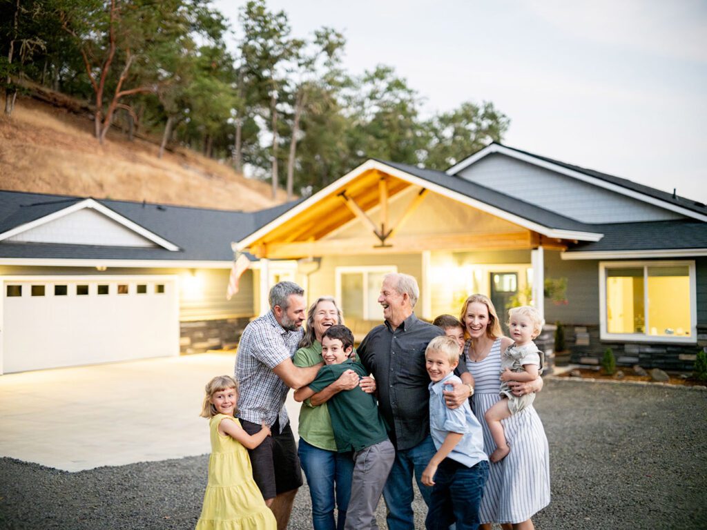 A multigenerational family together in front of their home.
