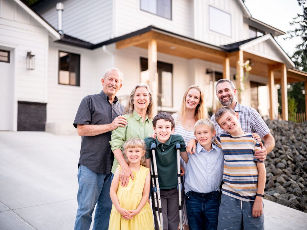 Multigenerational family in front of a HiLine Homes build.